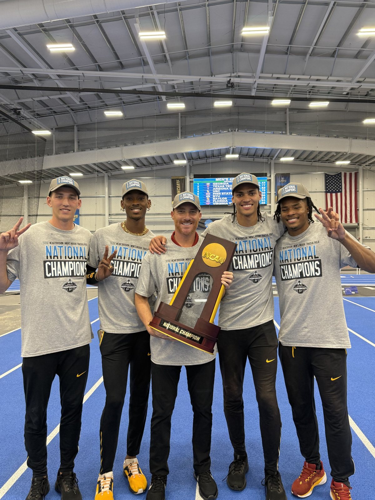 Coach Petersmeyer and USC athletes with the NCAA national championship trophy